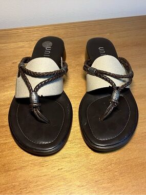 Unisa brown braided slide sandals with silver bead accents.